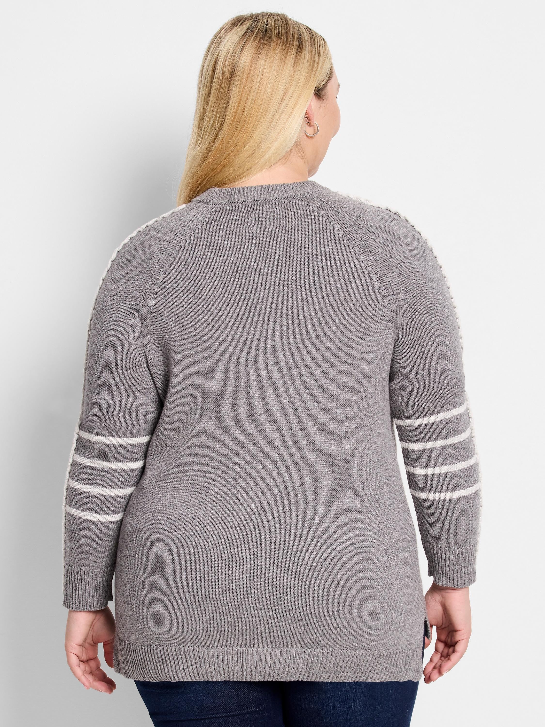 Grey knit sweater with white contrast stitching along raglan seams. Three white stripes wrap each sleeve above ribbed cuffs.