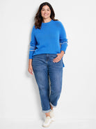 Blue ribbed crewneck sweater with white stripes on long sleeves and a split hem.