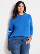 Blue crewneck sweater with white stitched raglan seams & two white stripes on upper arms. Ribbed cuffs & hem, side slits.
