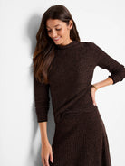 Brown and dark brown textured knit sweater; mock neck, three-quarter sleeves,  slightly flared hem.