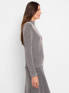 Black and blush pink pixelated knit mock neck sweater. Long sleeves.