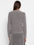 Black and blush pink knit sweater.  Geometric pattern; long sleeves; close-fitting.