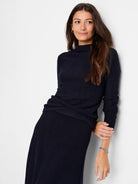 Navy blue, long-sleeved, mock neck sweater with textured knit.