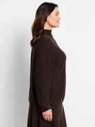 Brown textured knit sweater, high mock neck, long sleeves, dark brown trim at cuffs.
