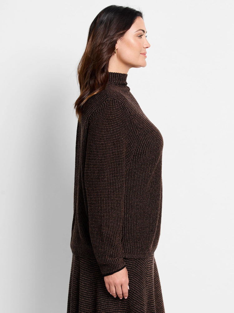Dark brown turtleneck sweater with a fine, speckled knit pattern. Features long sleeves with subtle black cuff trim.
