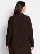 Dark brown, textured knit sweater.  Mock neck, long sleeves. Subtle lighter brown flecks throughout.