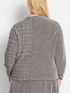 Black and off-white knit sweater.  Two-toned geometric pattern; back view shows a slightly flared hem.