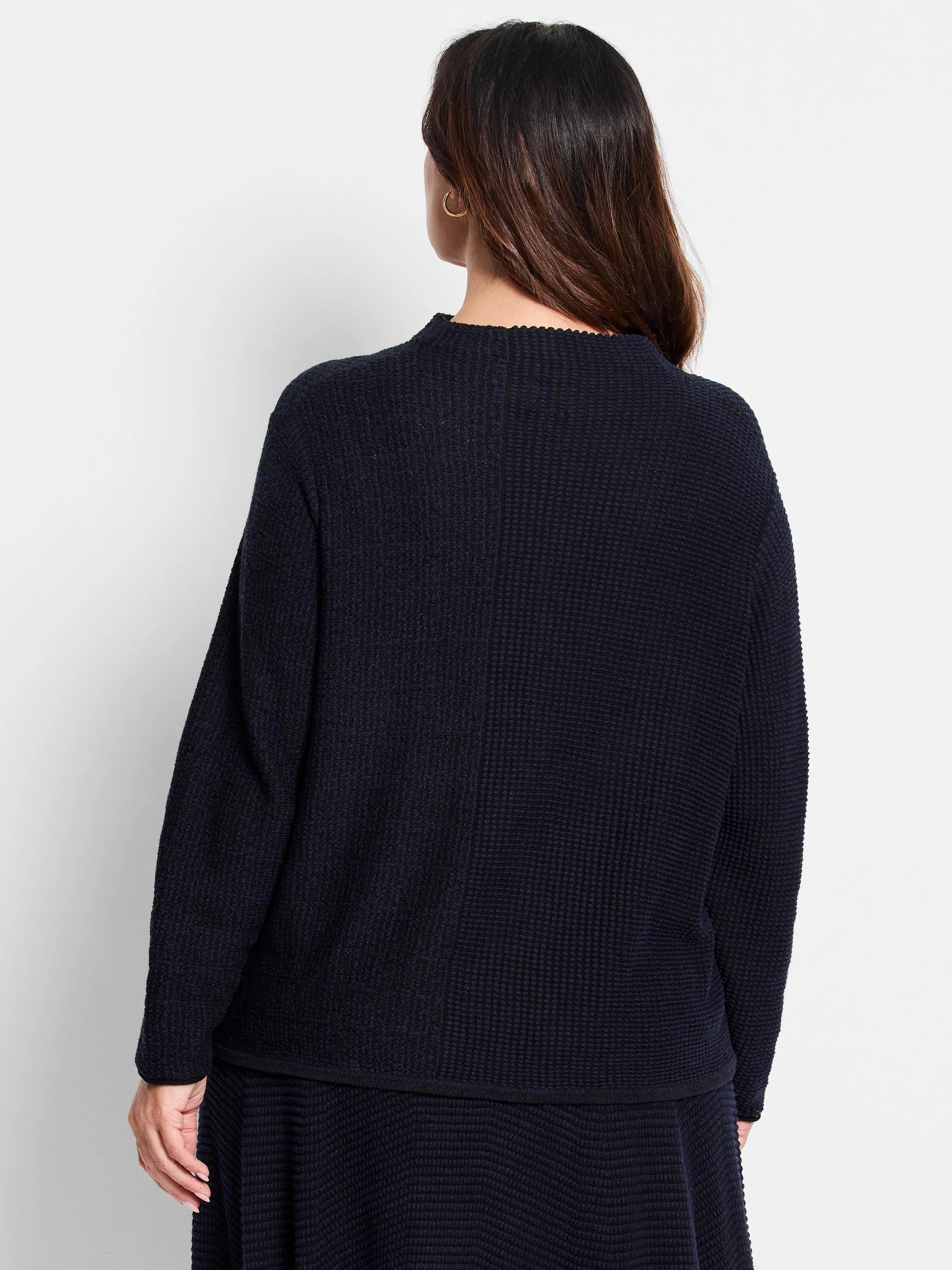 Dark navy blue waffle-knit sweater.  Long sleeves, crew neck.  Back view shown.