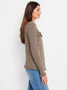 Taupe mix knit jacket with dark patterns, fringe on hem, cuffs, and chest pockets.