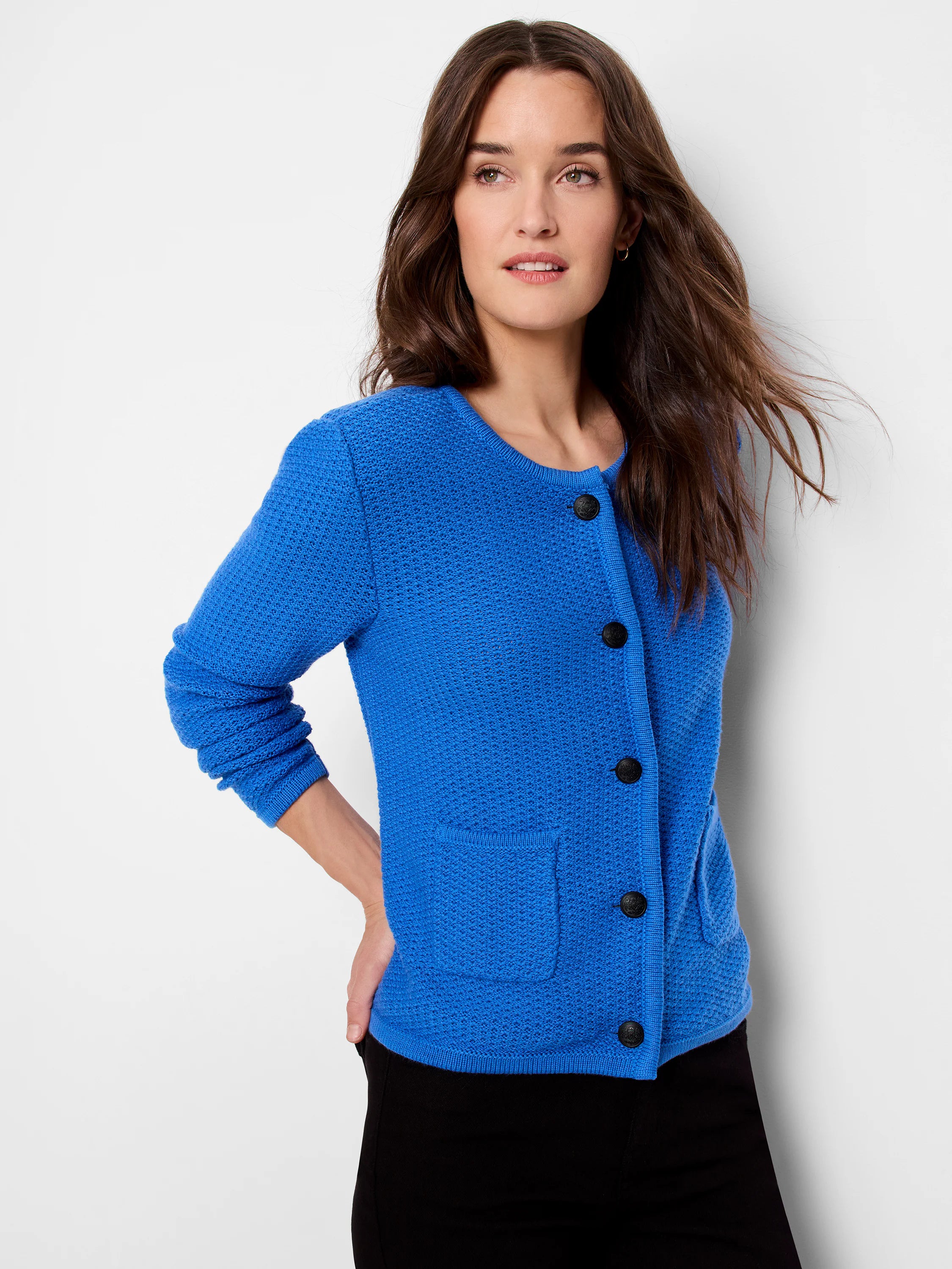 Bright blue textured sweater jacket with dark buttons and patch pockets.