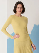 Pale yellow ribbed long-sleeve crewneck sweater.  Fine ribbing throughout.