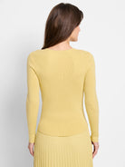 Pale yellow ribbed knit sweater tee, long sleeves,  V-neck.  Back view.