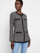 Black & white herringbone knit jacket with black buttons and trim.  Long sleeves.