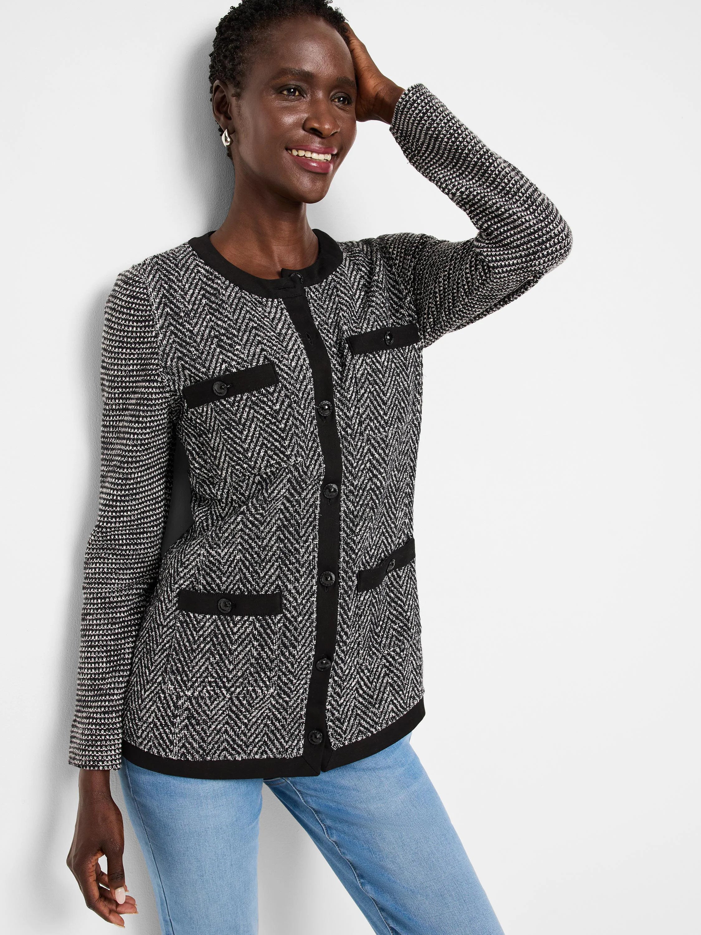 Black & white herringbone knit jacket with black trim, button front, and patch pockets.  Long sleeves, textured knit.