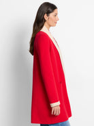 Red jacket with off-white collar and cuffs.  Open front, long sleeves, and a single pocket.