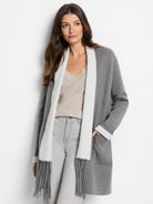 Gray cardigan with off-white collar and cuffs; long fringe detail.