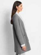 Gray reversible jacket with off-white interior.  Features long sleeves and pockets.