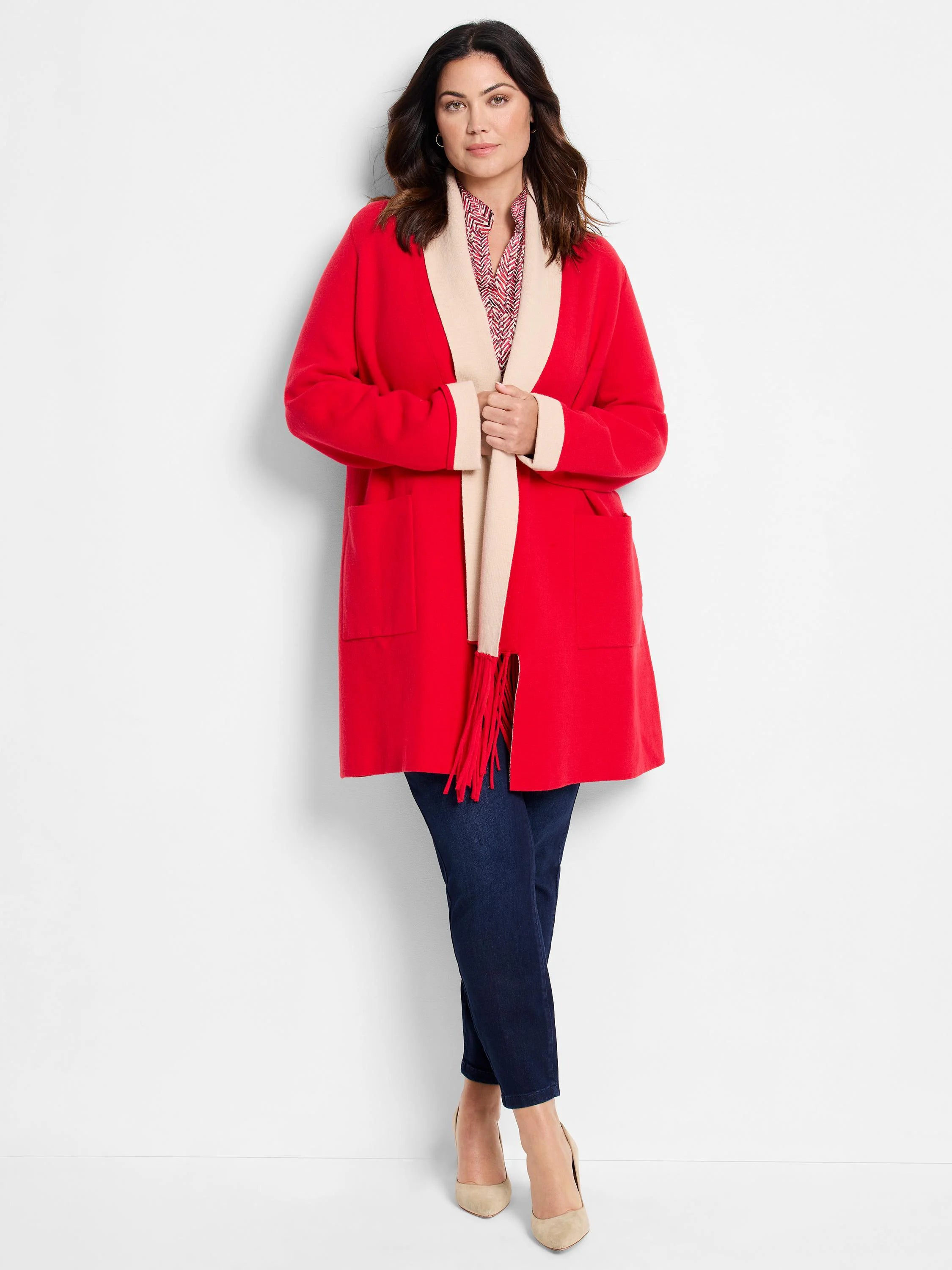 Red reversible jacket with beige collar and cuffs, and red fringe detail.  Features pockets.