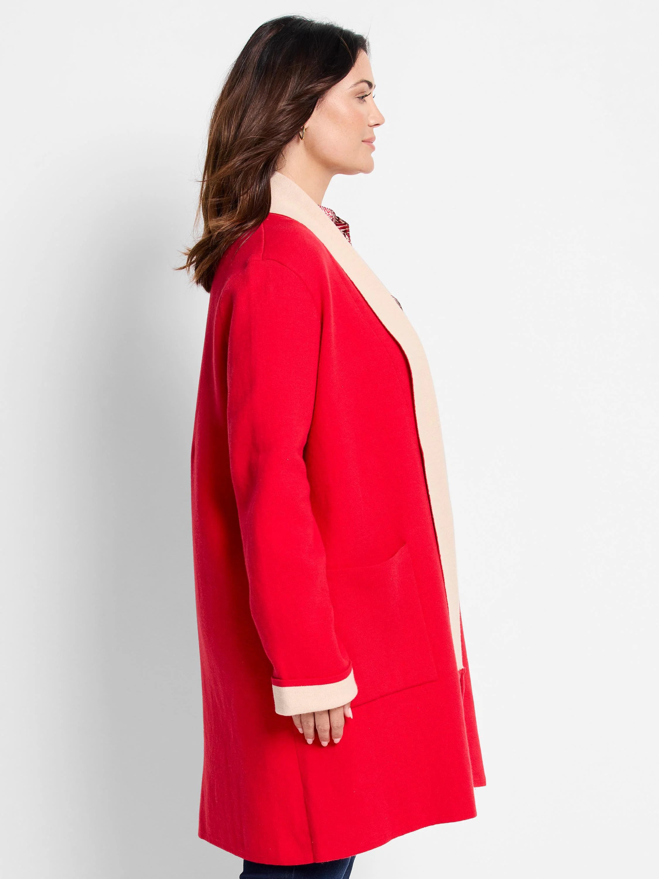 Red long jacket, reversible to beige. Features pockets and contrasting beige trim.