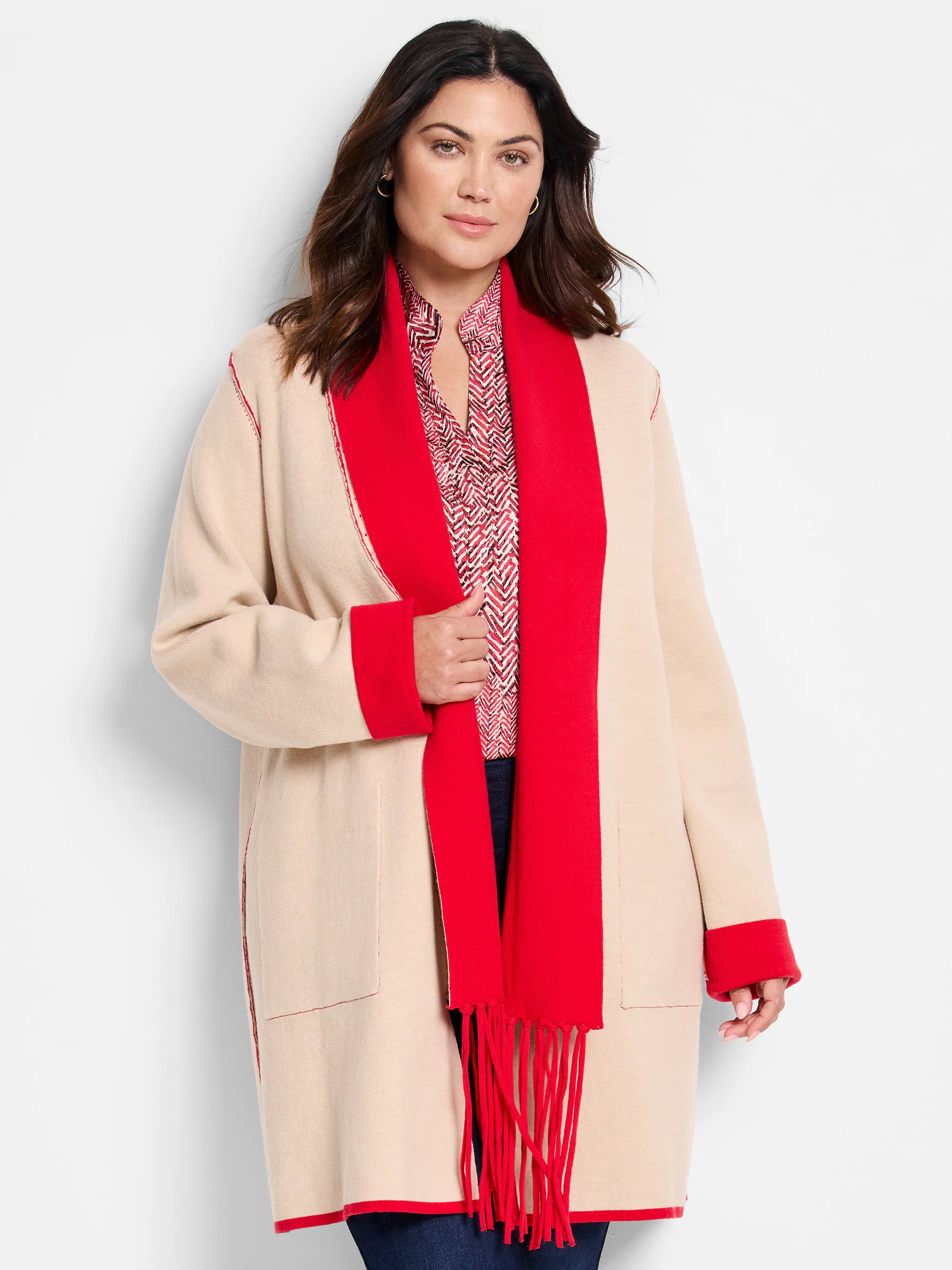 Beige jacket with red interior, cuffs, and fringed trim.  Reversible.