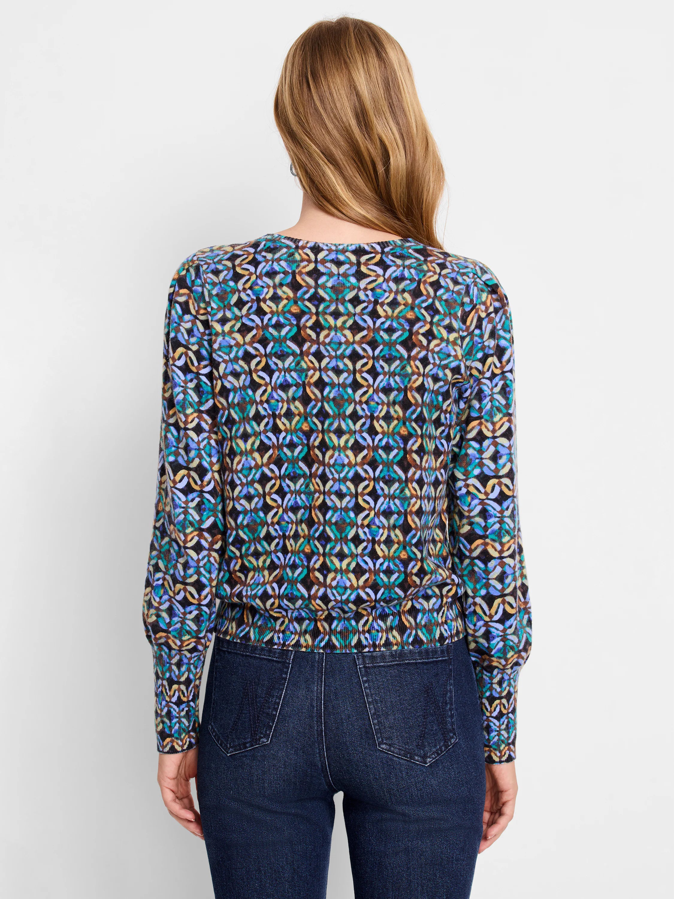 Long-sleeve sweater, black background with teal, purple, and beige abstract pattern.  Ribbed cuffs and hem.