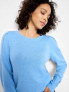 Light blue crewneck sweater featuring subtly gathered shoulders.