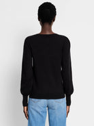 Black crewneck sweater with subtle puff sleeves and ribbed cuffs, viewed from the back.
