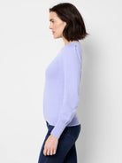 Lavender long-sleeve sweater with slight puff shoulders.