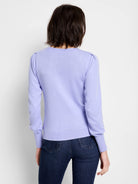 Light purple knit sweater with subtle puff shoulders, long sleeves, and ribbed cuffs and hem, shown on model's back.