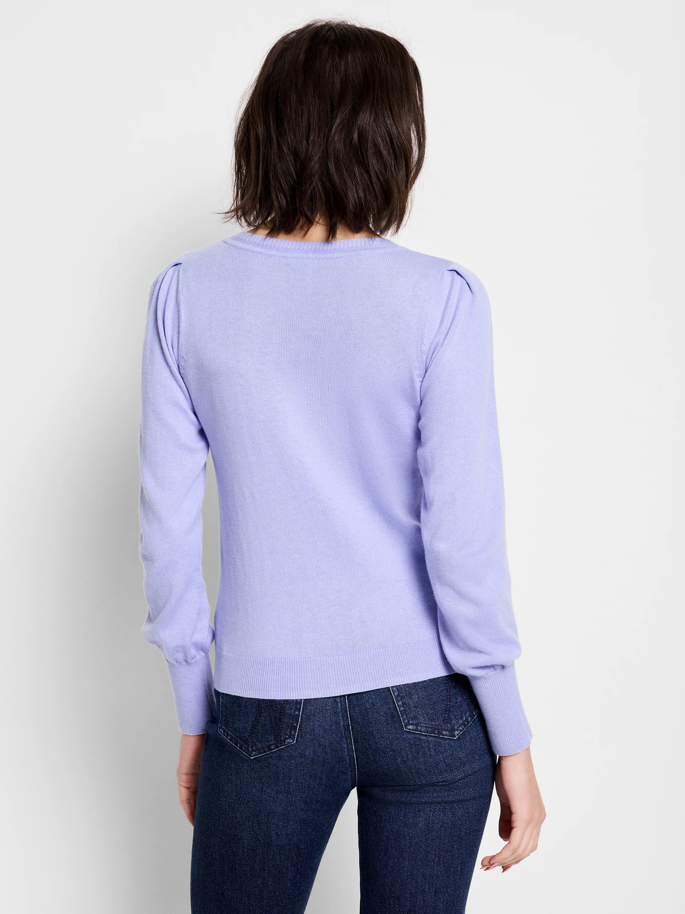 Light purple knit sweater with subtle puff shoulders, long sleeves, and ribbed cuffs and hem, shown on model's back.