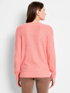 Back of pink waffle stitch sweater, with ribbed cuffs and hem.