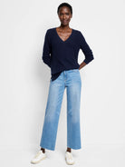 Navy blue V-neck sweater with a waffle stitch texture. Relaxed fit, long sleeves.