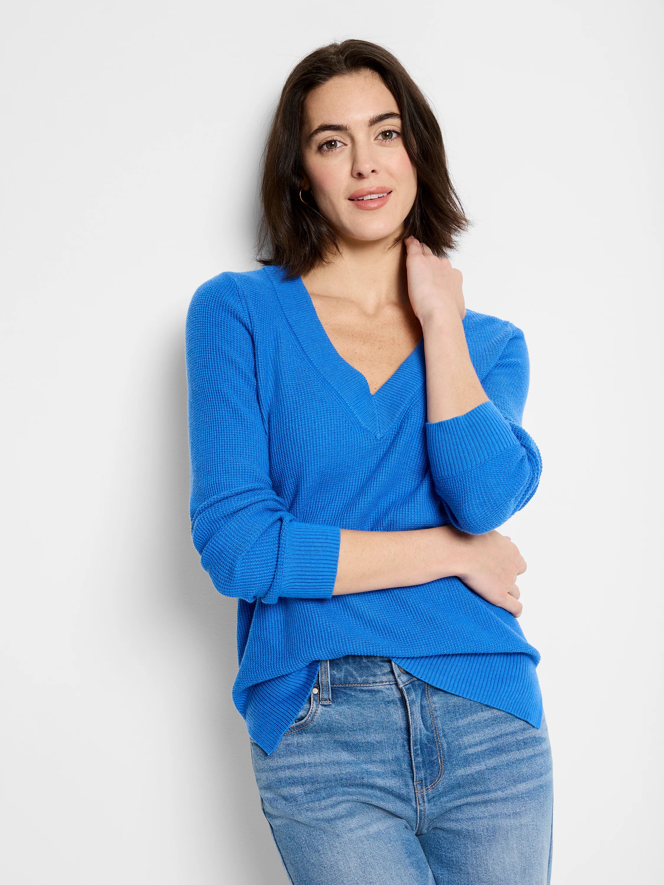 Vibrant blue waffle stitch V-neck sweater, with long sleeves and ribbed cuffs.