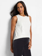 Off-white sleeveless knit tank with small, light-colored sequins forming a pattern on the side.