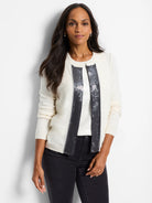 Off-white cardigan with dark gray sequin trim down the front.
