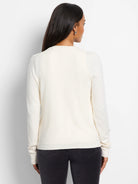 Off-white long-sleeved cardigan, shown from the back.  Features subtle sequin trim (not visible in this image).
