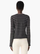 Black and white checkered tweed jacket.  Long sleeves, fitted.  The sweater has a textured appearance.