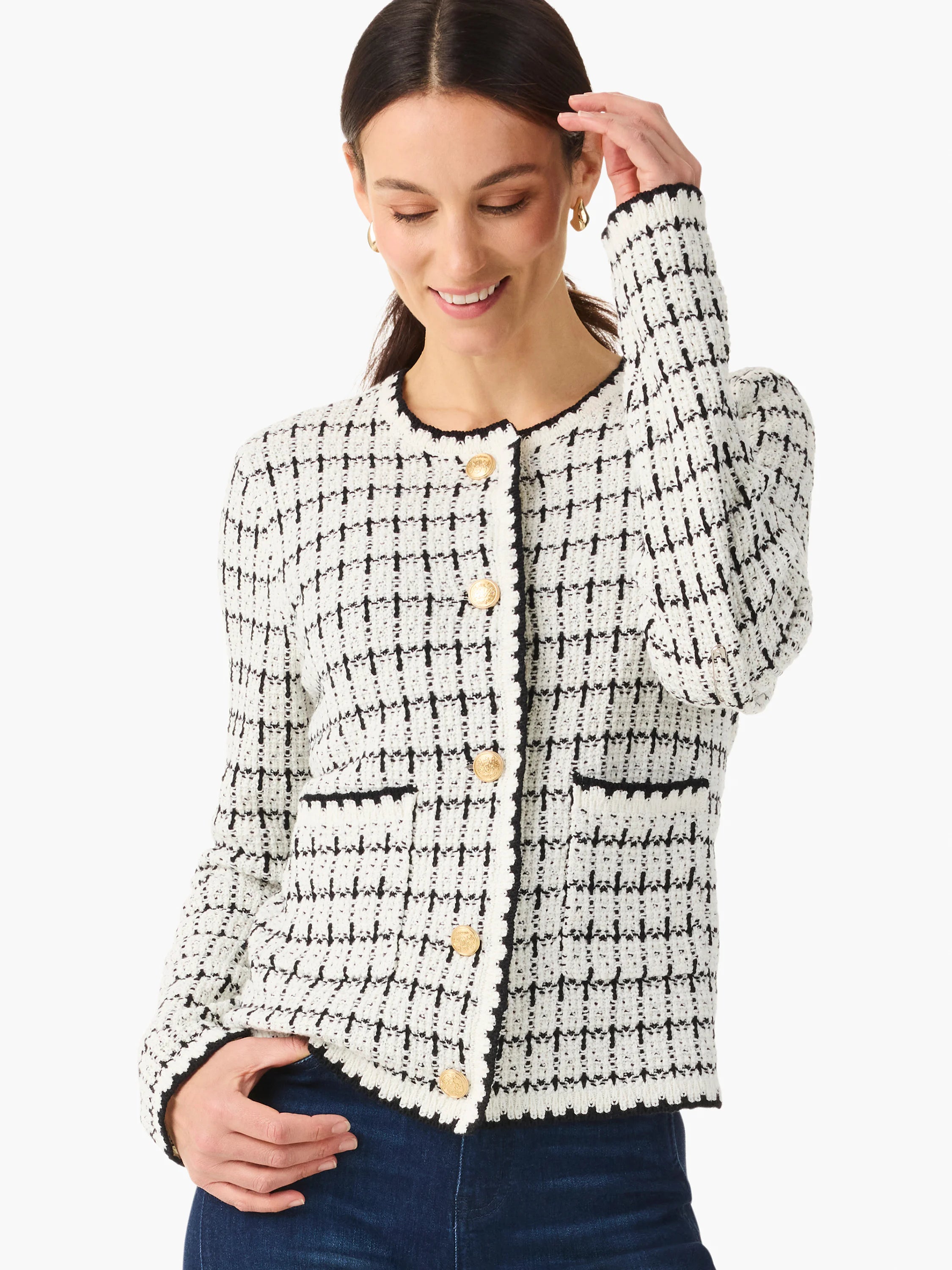 Off-white sweater jacket with black grid pattern, black trim, and gold buttons.