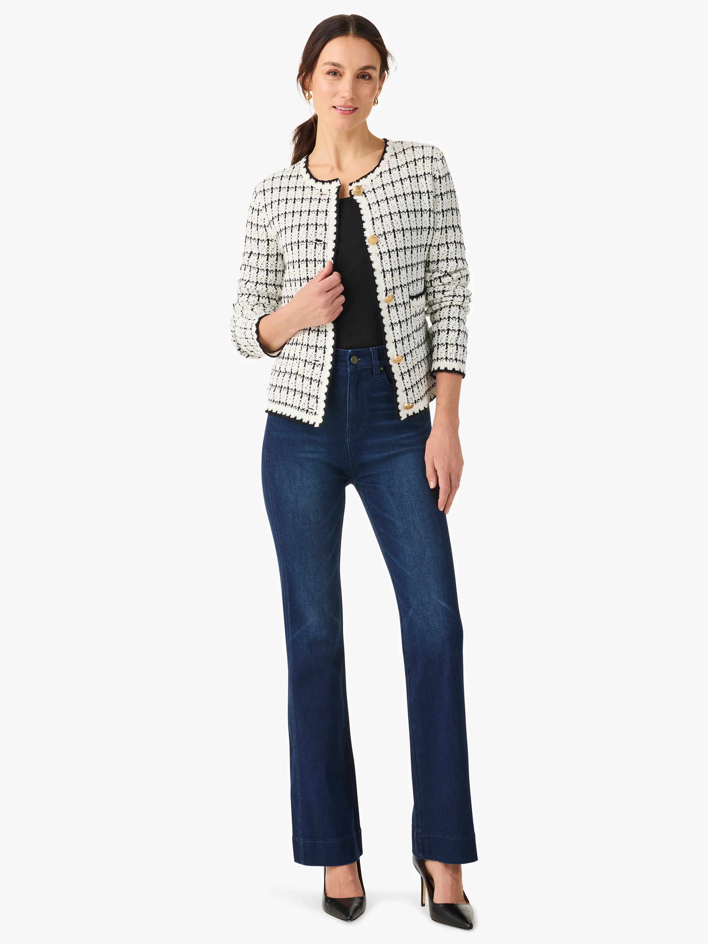 Off-white sweater jacket with black grid pattern, gold buttons, and black trim.