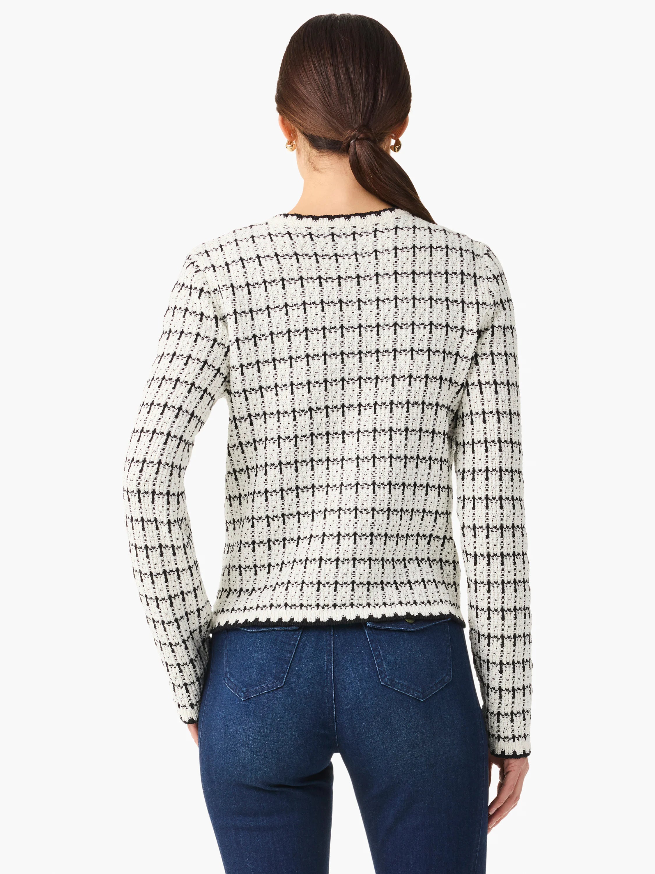 Off-white sweater jacket with black grid pattern, long sleeves, and dark trim.