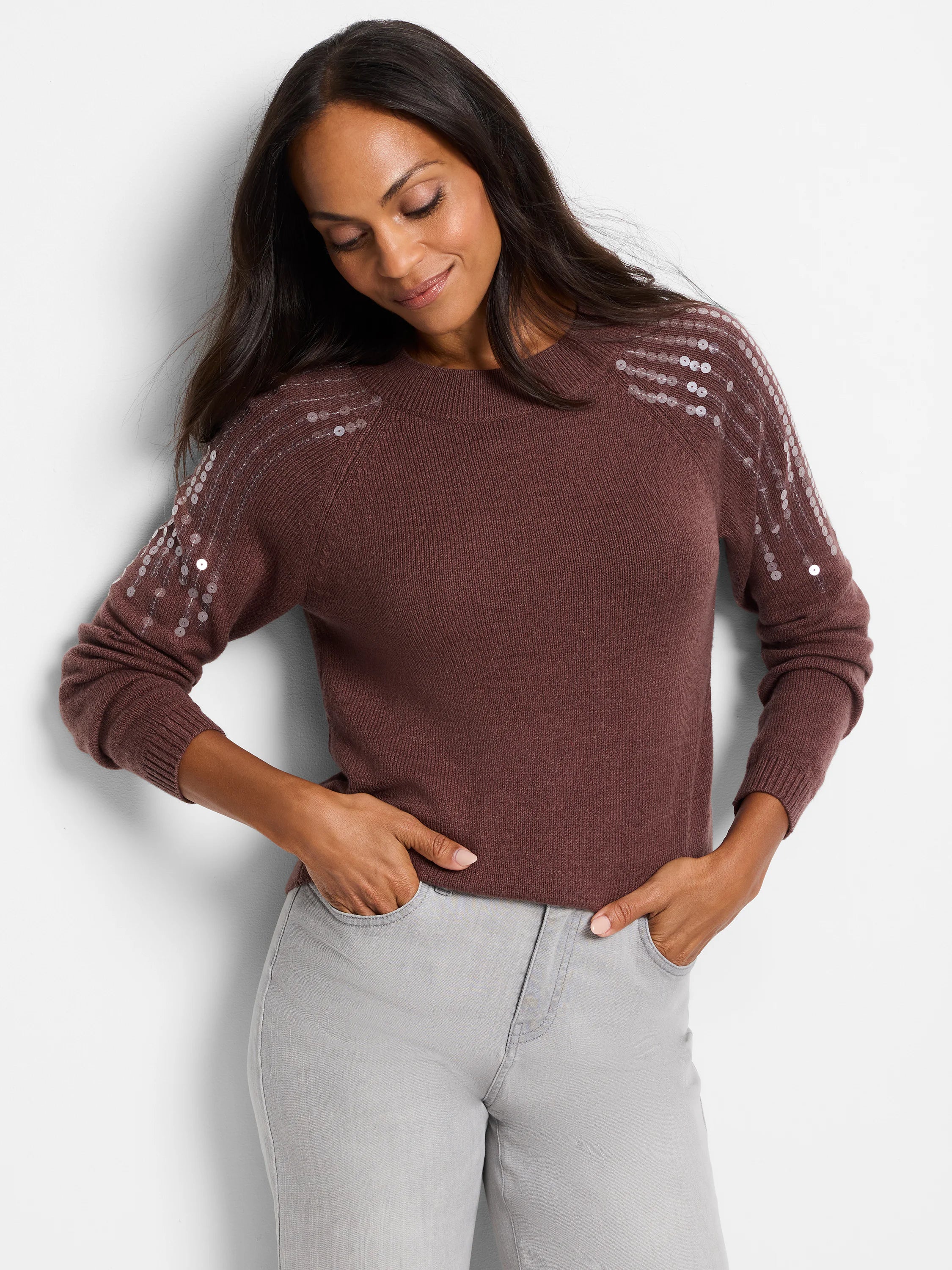 Brown long-sleeve sweater with light-colored sequins on the shoulders.