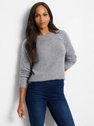 Gray sweater with subtle lighter gray vertical stripes on the shoulders.  Crew neck, long sleeves.