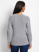 Gray knit sweater, raglan sleeves.  Small, light-colored sequins detail shoulder seams.