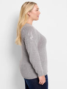 Gray long-sleeve sweater with light silver sequins on one shoulder.