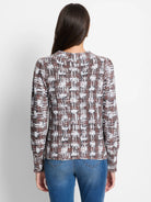 Brown, white, and rust waffle-knit sweater.  Features a textured, abstract pattern. Long sleeves, crew neck.