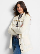 Off-white quilted puffer jacket with cream-colored knit sleeves and button front.