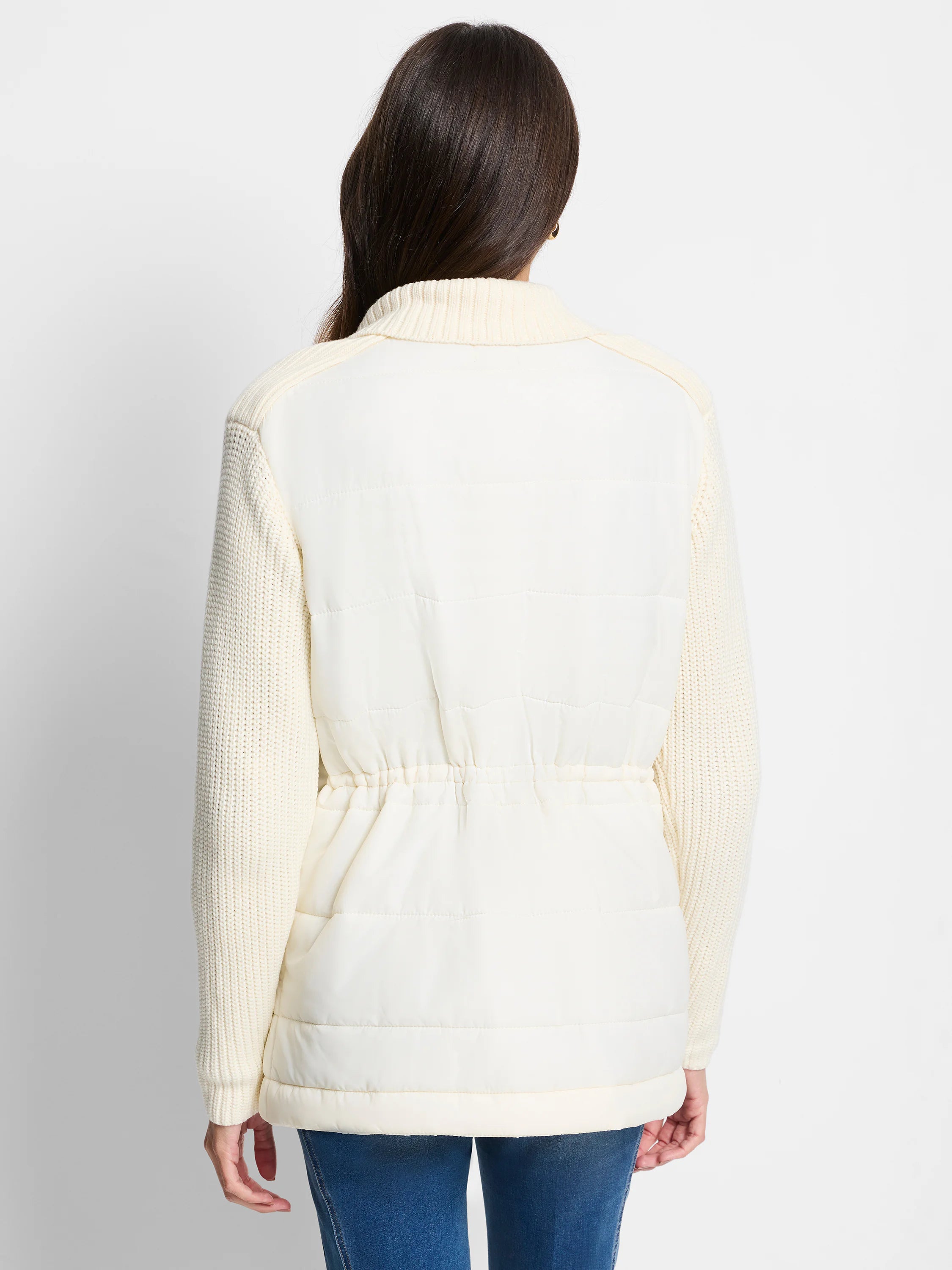 Off-white quilted puffer jacket with off-white knit sleeves.  Drawstring waist.