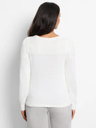 Off-white sweater with subtle sequin detailing on the shoulders and cuffs.  Long sleeves, crew neck.