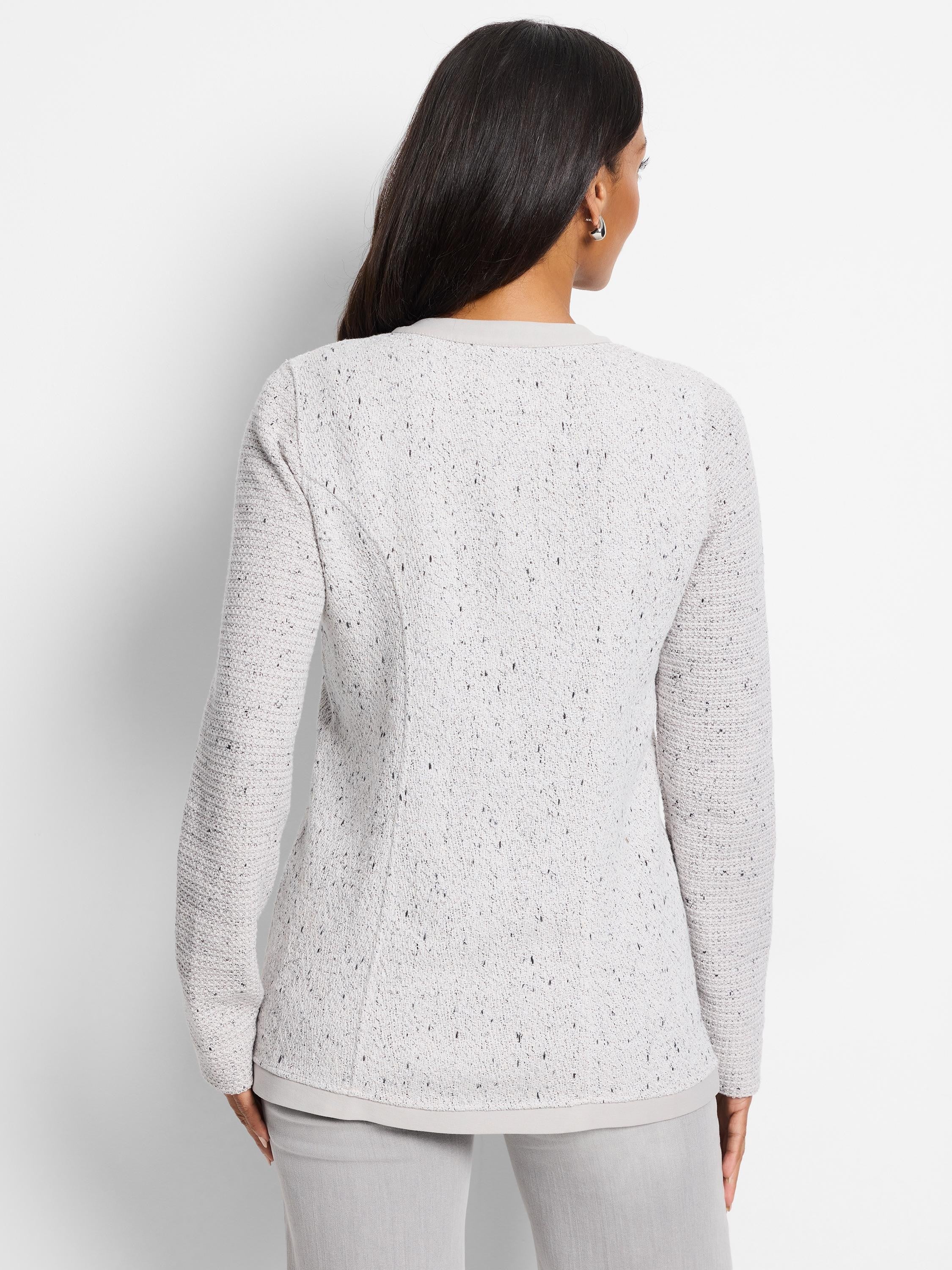 Light gray knit jacket with darker flecks; long sleeves, buttoned front.