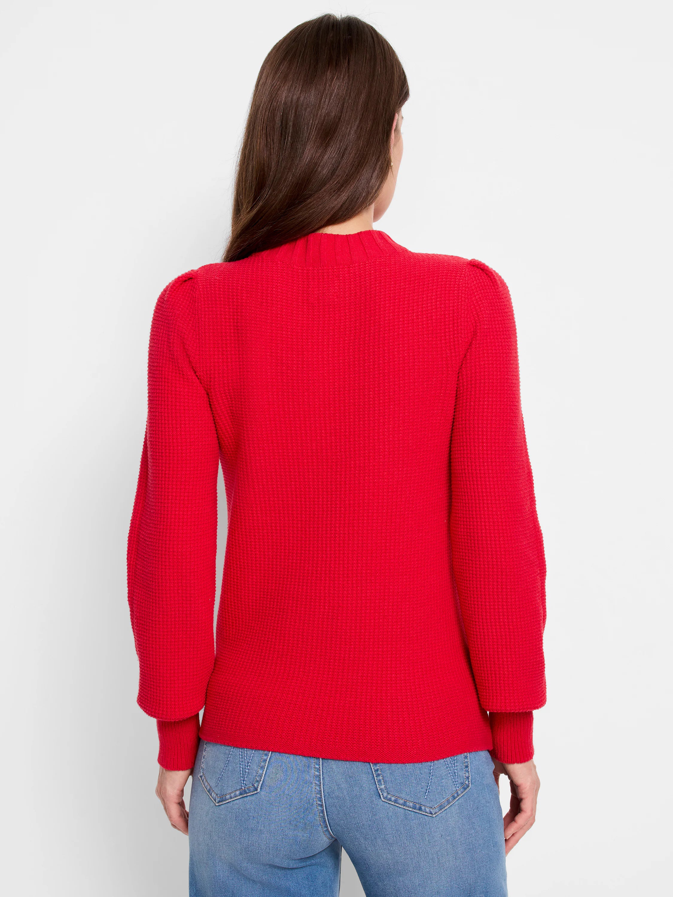 Red waffle-knit sweater, long sleeves, slightly puffed shoulders.  Back view.